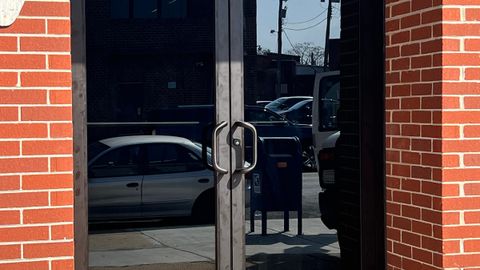 Glazed aluminum commercial entrance door in a brick storefront