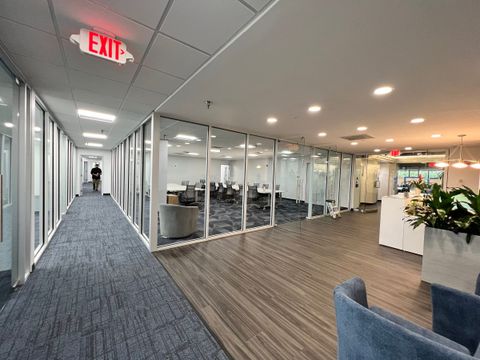Corridor lined with glass office partitions installed by Stonewing