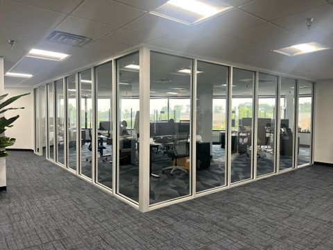 Aluminum-framed glass office partitions installed by Stonewing in an occupied office