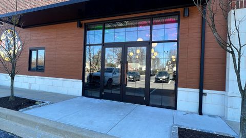 Finished aluminum storefront with glazed entrance doors on a commercial building, installed by Stonewing