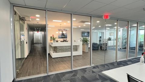 Glass office partitions and doors installed in an occupied office during a tenant fit-out